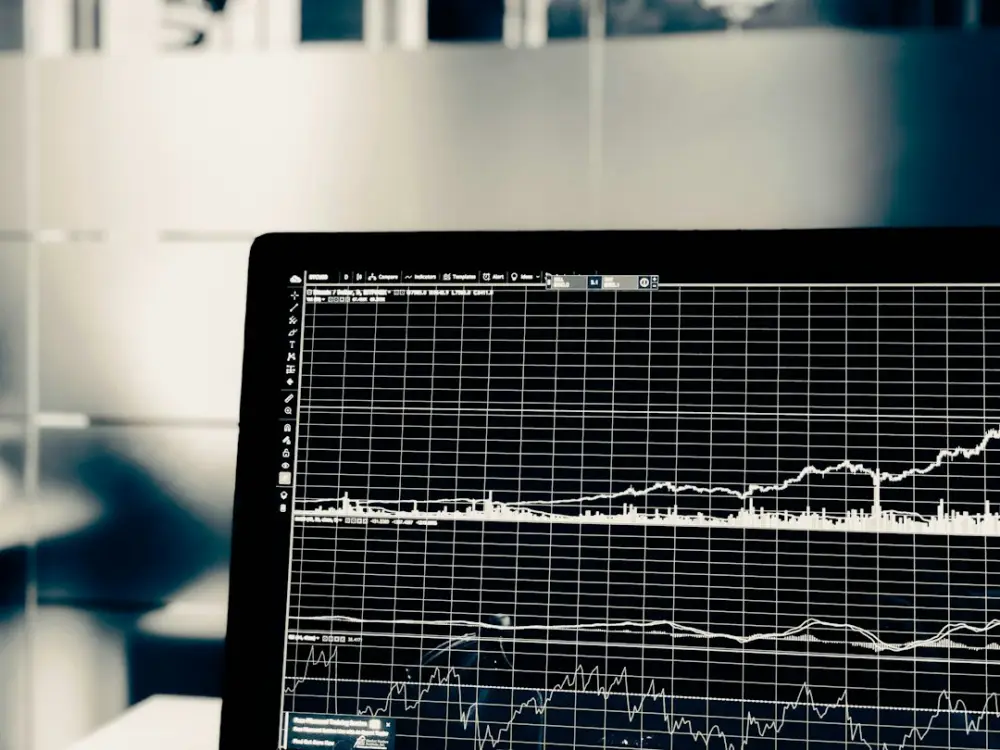 A computer screen displaying a white line graph of financial market data, illustrating cash flow management